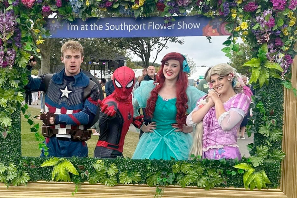 Photo of Starkidz entertainers dressed as Captain America, Spiderman and two princesses in a floral frame. 