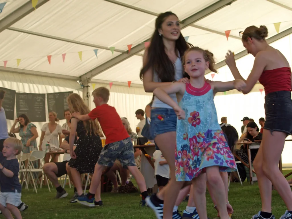 Children and families taking part in fun dancing and games under the marquee at the Parbold Village Show Friday Night Disco 2025.