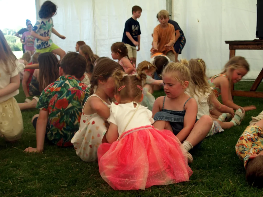 Marquee full of children playing a group sitting game at the Parbold Village Show Friday Night Disco 2025.